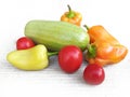 Fresh vegetables on a white background. Zucchini, peppers and tomatoes