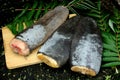 Several Frozen Beaver tails on a natural wooden background
