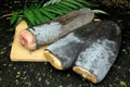 Several Frozen Beaver tails on a natural wooden background