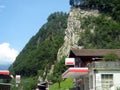 Several gas station buildings under the mountain. Picturesque nature and architecture outside the city