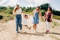 Several generations of women of the same family are walking along a dirt road outside the city, enjoying the time spent