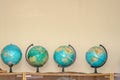 Several geographical globes on a shelf Royalty Free Stock Photo