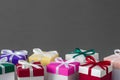 Several gift boxes with bright colorful lids and ribbons. Royalty Free Stock Photo