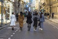 Several girls walking down the street in paris, rear view