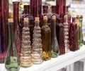 Several glass transparent bottles with cork stopper on a store shelf. Transparent glass bottles on a white shelf. Vintage glass Royalty Free Stock Photo