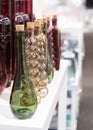 Several glass transparent bottles with cork stopper on a store shelf. Transparent glass bottles on a white shelf. Vintage glass Royalty Free Stock Photo