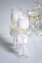 Several glasses with champagne poured stand on a table on a white tablecloth