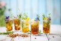 several glasses of iced herbal tea with assorted herbs garnish Royalty Free Stock Photo