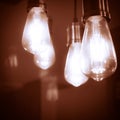 soft glowing vintage-style light bulbs. bokeh effect abstract background. ideas, technology, or design element Royalty Free Stock Photo