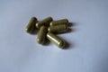 Several green capsules of moringa