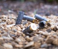 Several grey spent shotgun cartridges on the ground on a public shooting area. Concepts of danger, action, shooting and war Royalty Free Stock Photo