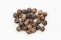 Several hainan black peppercorns close up on gray Royalty Free Stock Photo