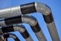 Several heating pipes with a turn against the blue sky Royalty Free Stock Photo