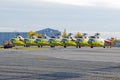 Several helicopters parked at the airport for repairs