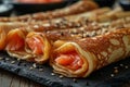 Several homemade thin pancakes stuffed with salmon, close up black plate, rustic style, treat for Shrove Royalty Free Stock Photo