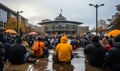 Group of People Sitting on Ground in Rain Royalty Free Stock Photo