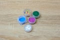 Several jars of multicolored sparkles for the design of nails or make-up on the desktop