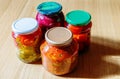 Several jars of tinned vegetables on a wooden table Royalty Free Stock Photo