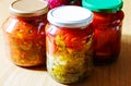 Several jars of tinned vegetables on a wooden table Royalty Free Stock Photo
