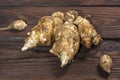 Several Jerusalem artichoke tubers on a wooden table. Helianthus tuberosus. Close up Royalty Free Stock Photo