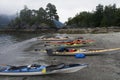 Several kayaks pulled up on the beach in Nuchatlitz Inlet