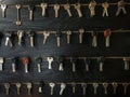 Several Keys type such as household and car key use for copying or duplicating hang on the wall in the locksmith workshop. Many va Royalty Free Stock Photo