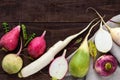 Several kinds of radish daikon, Chinese red, green on a wooden table.