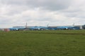 Several KLM aircrafts idle on landing strip Aalsmeerbaan of Amsterdam Schiphol Airport in the Netherlands, parked due to cancelled