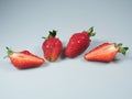 A pair of fresh berries and one cut strawberries lie on the table Royalty Free Stock Photo