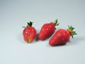 Several large and fresh strawberries lie on the table