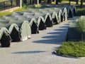 Several large military tents on the paved area