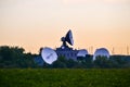 Several large satellite communications antennas in the field in the early morning. Space Communication Center Royalty Free Stock Photo