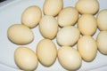 Several light colored easter eggs on white plate