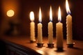 Several lighten candles on wooden surface on dark background Royalty Free Stock Photo