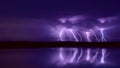 Several lightning strikes during a strong thunderstorm over the lake Royalty Free Stock Photo