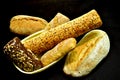 Still life composed of several loaves of bread on a dark background Royalty Free Stock Photo