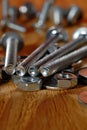 Several long screws for home workshop on a wooden surface closeup