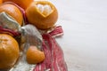 Several mandarins and peel in form of heart are on the ribbon