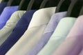 Several men`s shirts of different colors on the hangers. Selective focus. Royalty Free Stock Photo