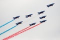 Several military aircraft symmetrically perform aerobatics