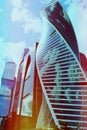 Several modern buildings with a glass facade against the sky with clouds, close-up. Royalty Free Stock Photo