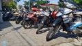 several motorbikes parked in the yard of a bank