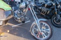 Several motorcycles, mostly Harley-Davidson models, parked on an asphalt or concrete surface under natural and diffuse lighting Royalty Free Stock Photo