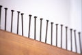 Several nails hammered into a wooden board close-up. The view is tilted diagonally focus Royalty Free Stock Photo