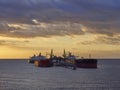 Several Oil Tankers discharging oil Products at an Offshore jetty at the Anchorage of Freeport in the Bahamas on one dawn morning.