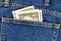 Several one dollar bills in the back pocket of jeans. Concept of absentminded person, potential victim of theft. Royalty Free Stock Photo