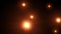 Several orange shining lights moving from right to left on black background in 4k