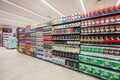 Several packs of coffee on a wall of shelves. Front view, full background. Royalty Free Stock Photo