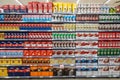 Several packs of coffee on a wall of shelves. Front view, full background.