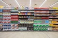 Several packs of coffee on a wall of shelves. Front view, full background.